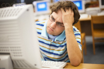 Frustrated Student Working on a Computer --- Image by © Randy Faris/Corbis